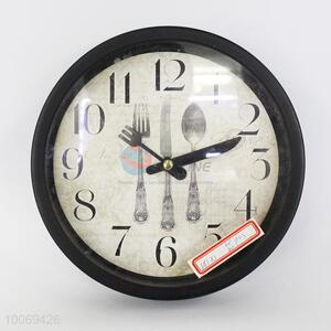 Black roundl plstic wall clock with tableware pattern